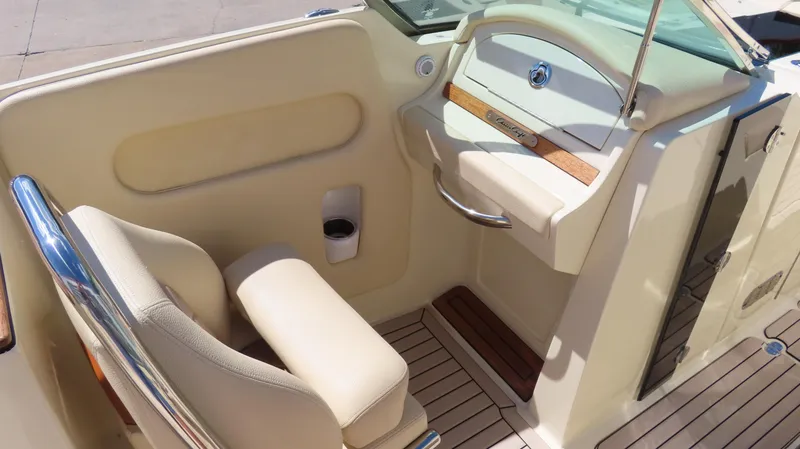 Slide: The Image of 2018 Chris-Craft Launch 34 interior with beige seating and wooden accents. - 34