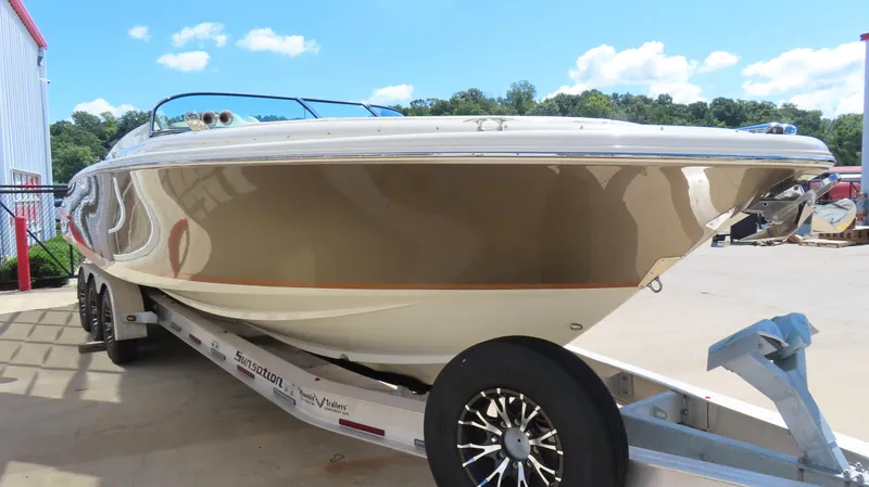 Slide: The Image of 2018 Chris-Craft Launch 34 boat on trailer, outdoors under blue sky. - 5