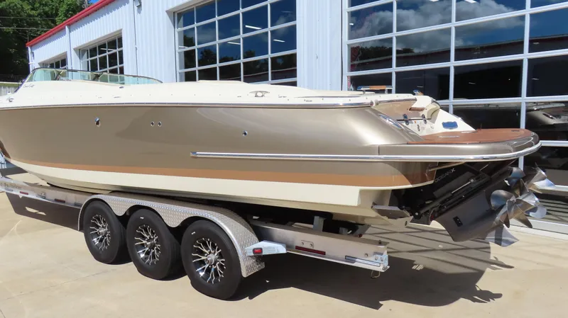 Slide: The Image of 2018 Chris-Craft Launch 34 boat on trailer, parked outside a garage. - 9