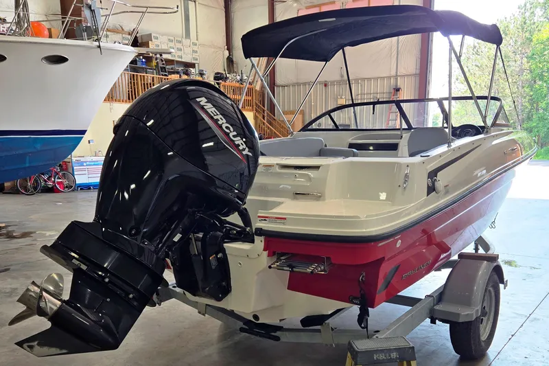 Slide: The Image of 2023 Bayliner VR4 Bowrider OB with Mercury outboard in a garage setting. - 4