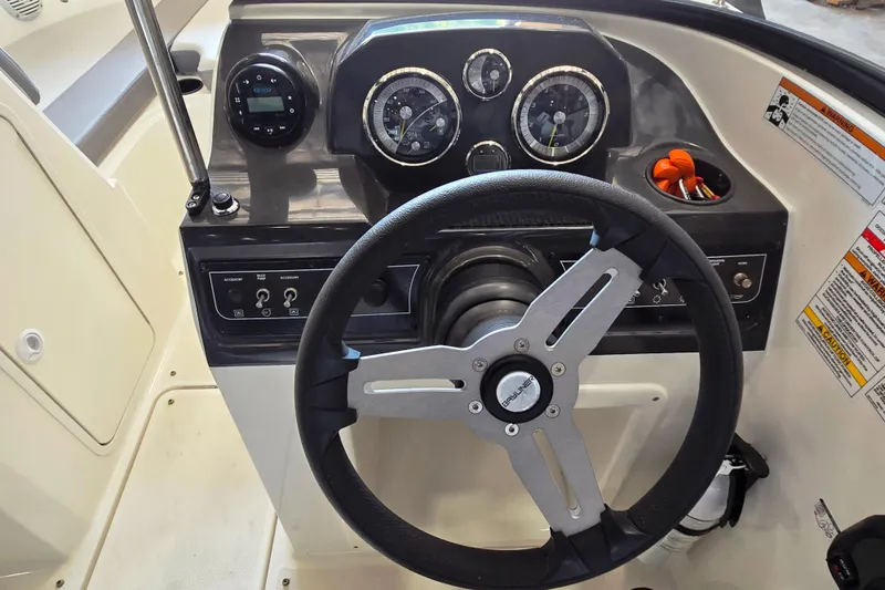 Slide: The Image of 2023 Bayliner VR4 Bowrider OB dashboard with steering wheel and instrument panel. - 8