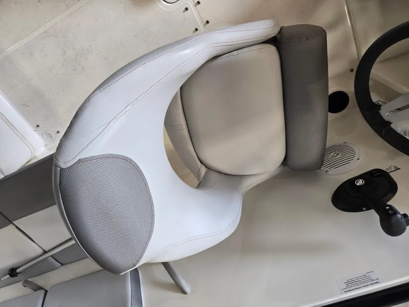 Slide: The Image of 2023 Bayliner VR4 Bowrider OB interior with white and gray seating and steering wheel. - 9