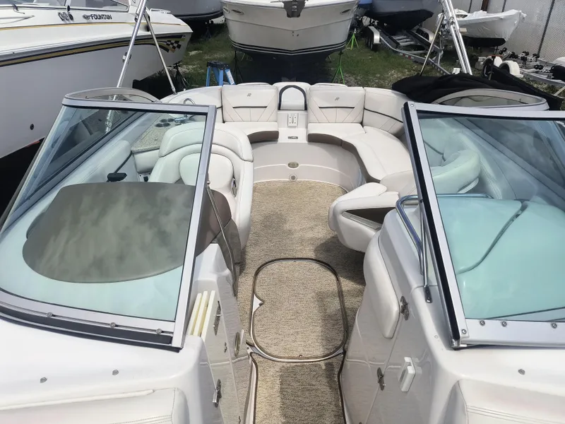 Slide: The Image of 2007 Four Winns 240 Horizon boat interior with plush seating and open deck layout. - 12