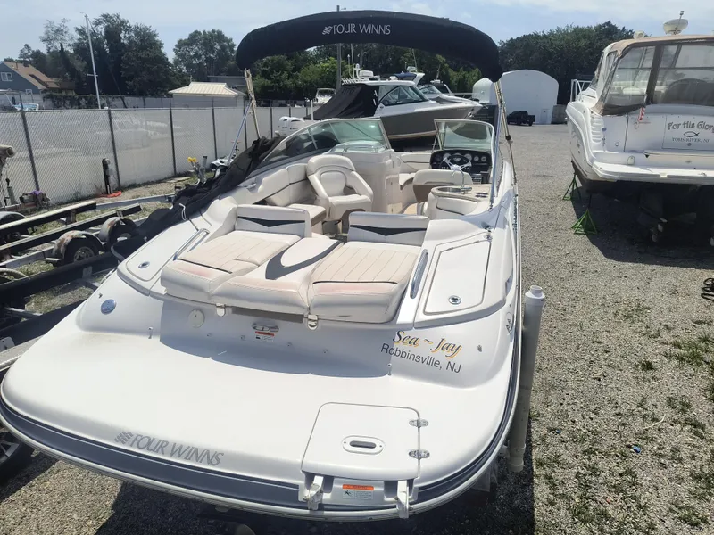 Slide: The Image of 2007 Four Winns 240 Horizon boat with seating, parked in a marina. - 3