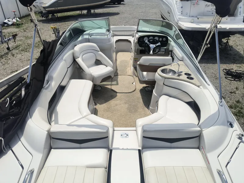 Slide: The Image of 2007 Four Winns 240 Horizon boat interior with white seating and steering console. - 5