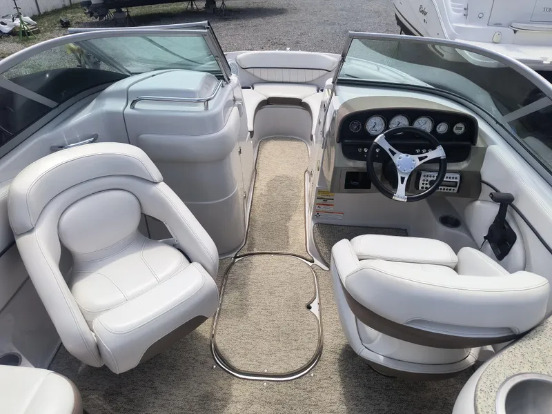 Slide: The Image of 2007 Four Winns 240 Horizon boat interior with white seating and modern dashboard. - 7