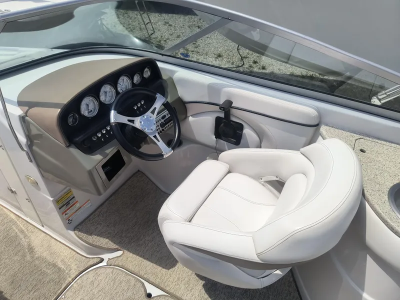 Slide: The Image of 2007 Four Winns 240 Horizon boat cockpit with steering wheel and gauges. - 8