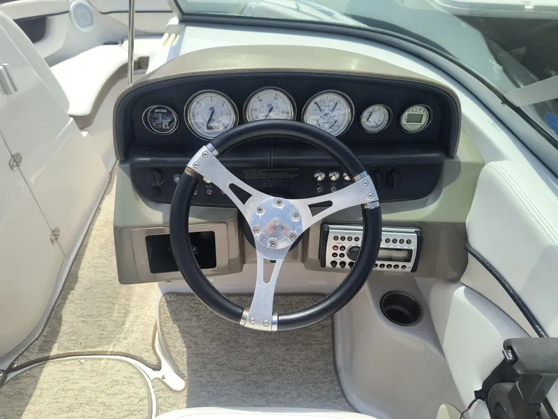 Slide: The Image of 2007 Four Winns 240 Horizon boat dashboard with steering wheel and instrument panel. - 9