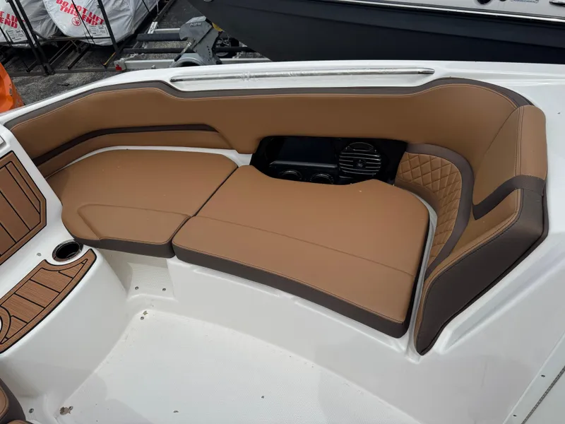 Slide: The Image of Luxurious seating on 2025 Yamaha Boats 252SD, featuring tan and brown upholstery with cup holder. - 10