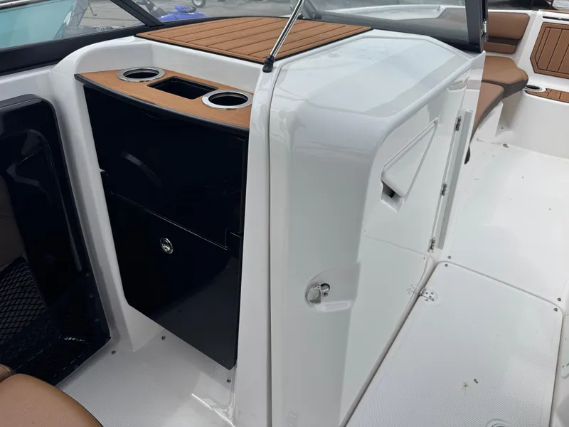 Slide: The Image of 2025 Yamaha Boats 252SD interior with cup holders and seating area. - 16