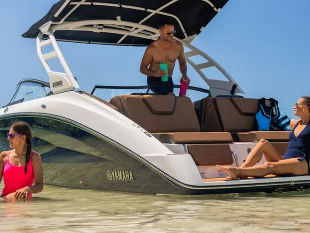 Slide: The Image of 2025 Yamaha Boats 252SD with people relaxing on a sunny beach day. - 32