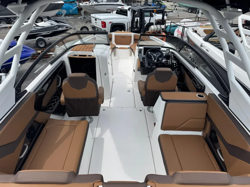 Slide: The Image of 2025 Yamaha Boats 252SD interior with brown seating and modern dashboard. - 6