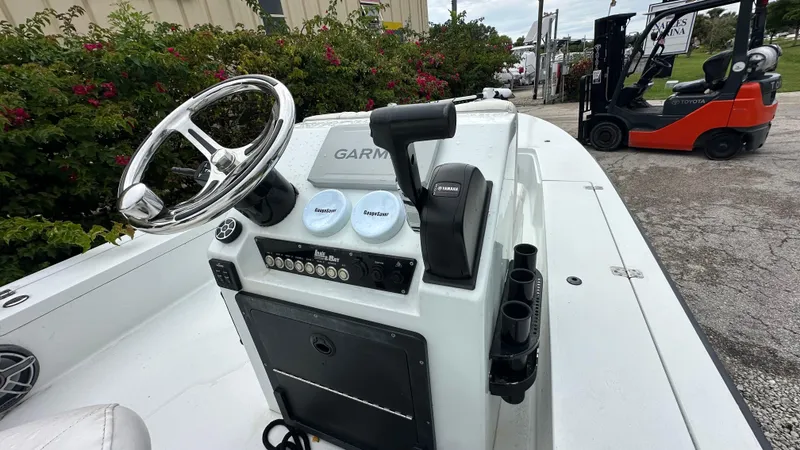 Slide: The Image of 2018 Lake & Bay Boca Grande 20 boat console with steering wheel and controls. - 6