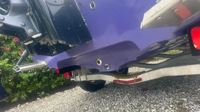 Slide: The Image of 2018 Lake & Bay Boca Grande 20 boat on trailer, close-up of hull and motor. - 7