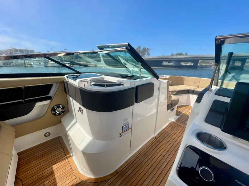 Slide: The Image of 2019 Sea Ray SLX 310 boat interior with sleek design and wooden flooring. - 15