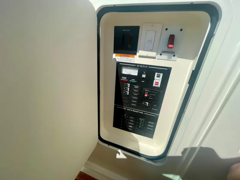 Slide: The Image of Electrical panel inside 2019 Sea Ray SLX 310 boat, featuring switches and controls. - 32