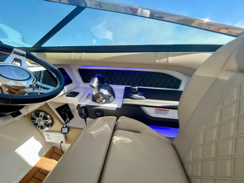 Slide: The Image of Luxurious interior of 2019 Sea Ray SLX 310 boat with modern steering and controls. - 38