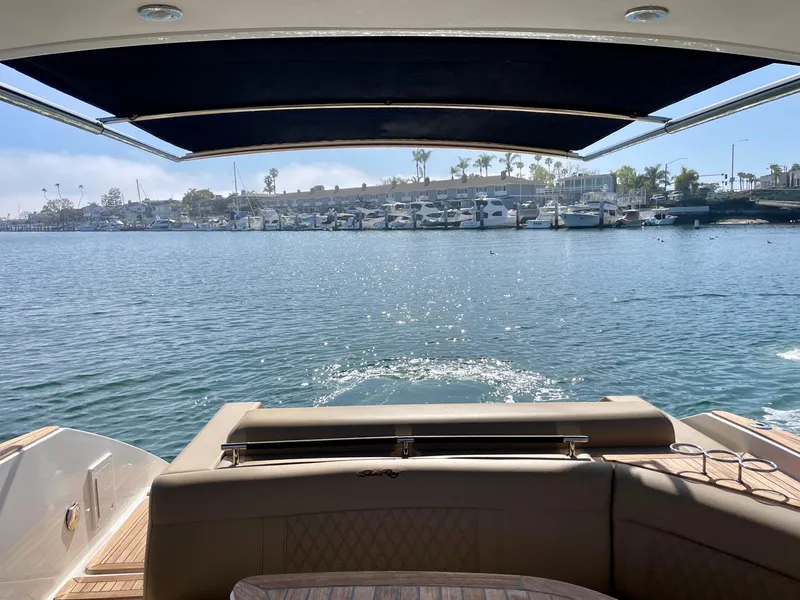 Slide: The Image of 2019 Sea Ray SLX 310 boat with waterfront view and marina in the background. - 49