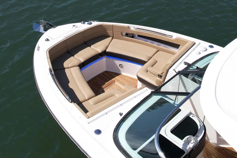 Slide: The Image of 2019 Sea Ray SLX 310 boat with spacious seating and elegant design on the water. - 7