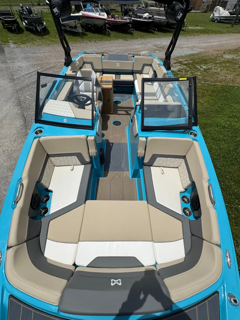 Slide: The Image of 2025 Heyday H22 boat interior with beige seating and blue accents, featuring open windshield. - 4