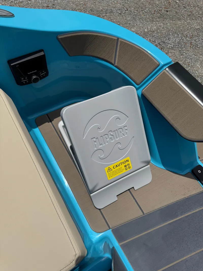 Slide: The Image of 2025 Heyday H22 boat interior with FlipSurf feature and caution label. - 6