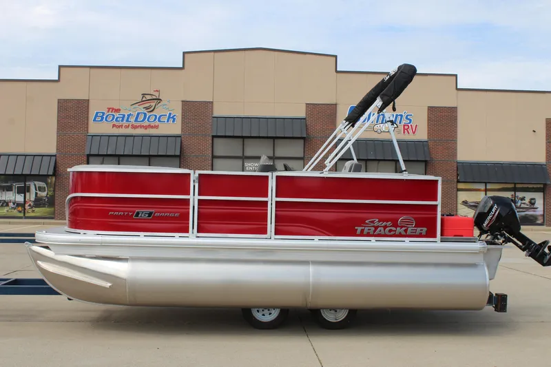 The Image of 2026 Sun Tracker Party Barge 16 DLX pontoon boat, red and silver, at dealership. - 0
