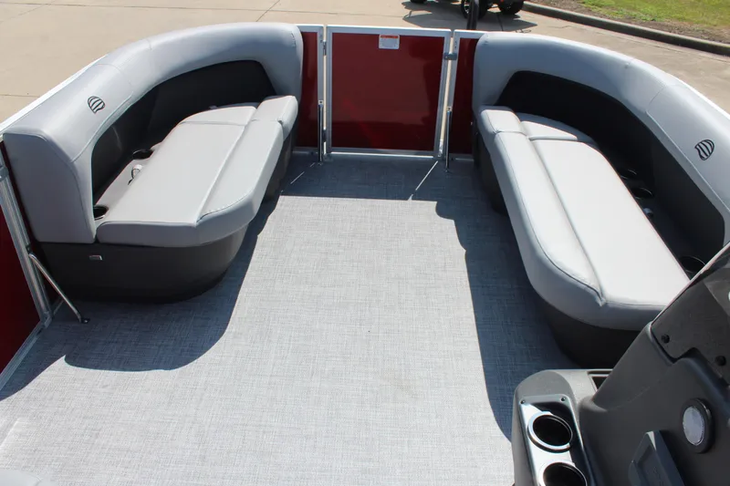 Slide: The Image of 2026 Sun Tracker Party Barge 16 DLX interior with gray seating and red paneling. - 11