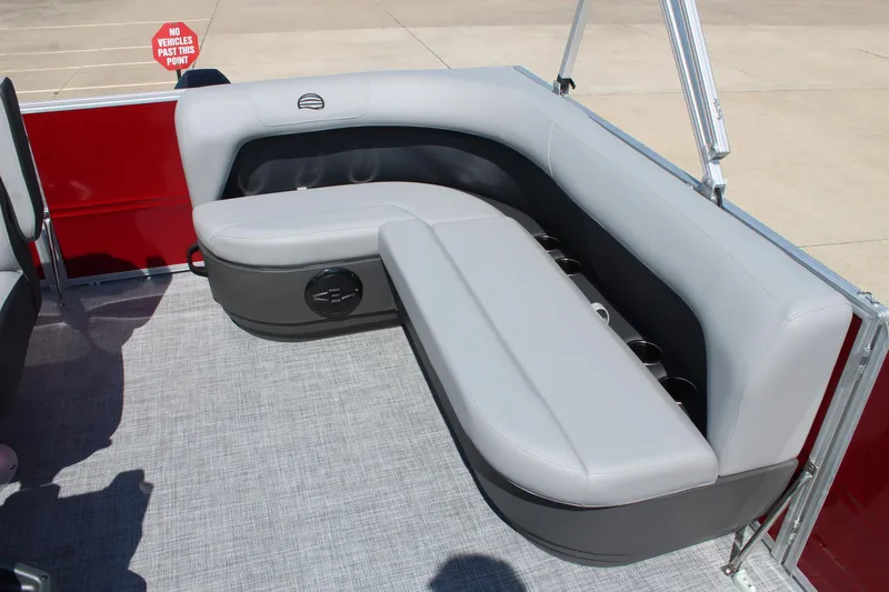 Slide: The Image of 2026 Sun Tracker Party Barge 16 DLX interior seating with gray upholstery and cup holders. - 12