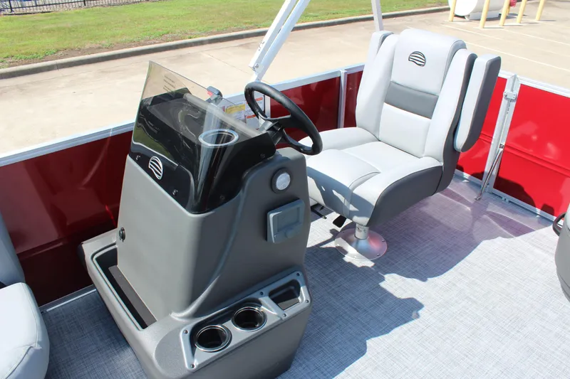 Slide: The Image of 2026 Sun Tracker Party Barge 16 DLX interior with steering console and captain's chair. - 13