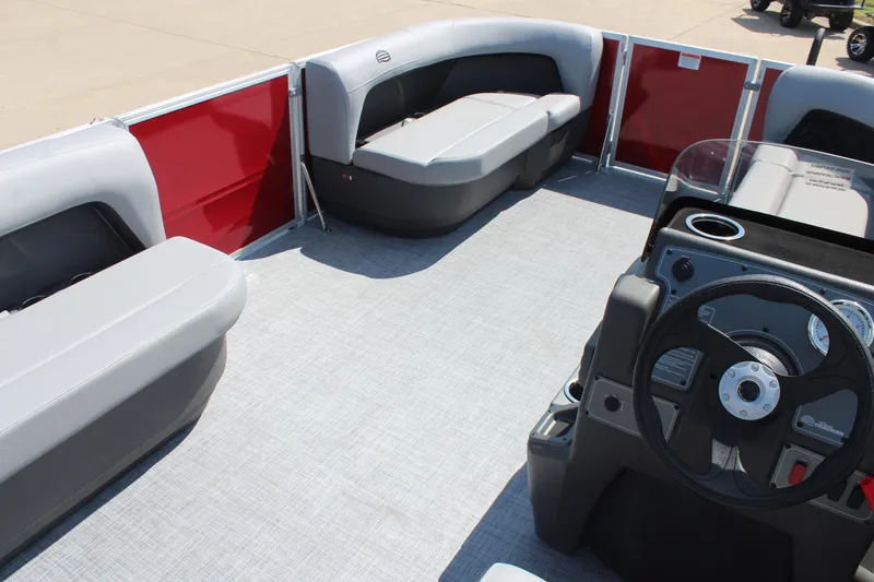Slide: The Image of 2026 Sun Tracker Party Barge 16 DLX interior with gray seating and steering console. - 15