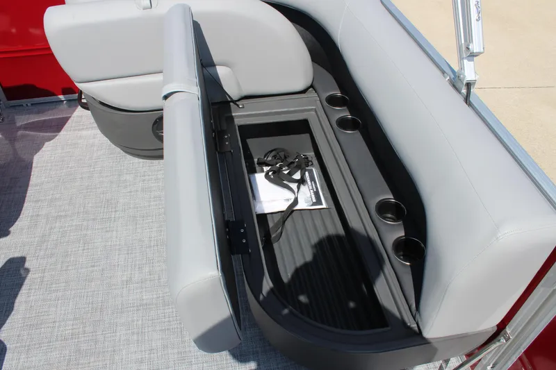 Slide: The Image of 2026 Sun Tracker Party Barge 16 DLX seat storage with cup holders and accessories. - 16