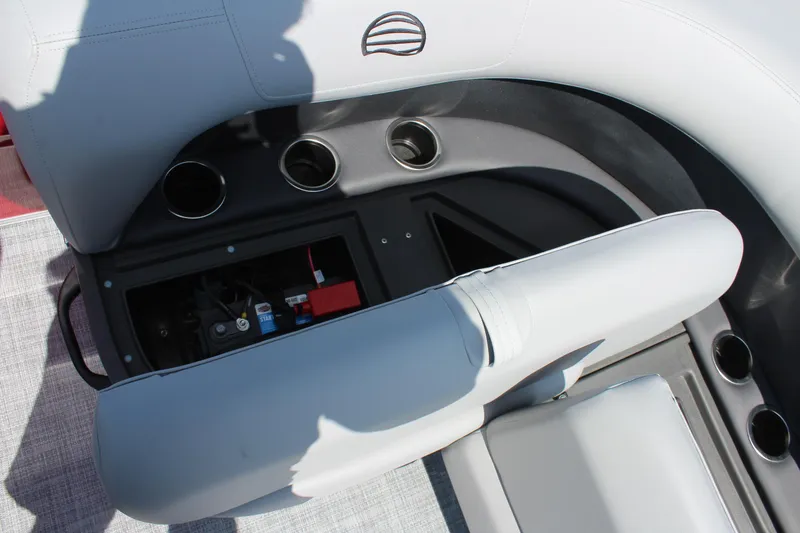 Slide: The Image of Sun Tracker Party Barge 16 DLX 2026 interior with cup holders and storage compartment. - 17