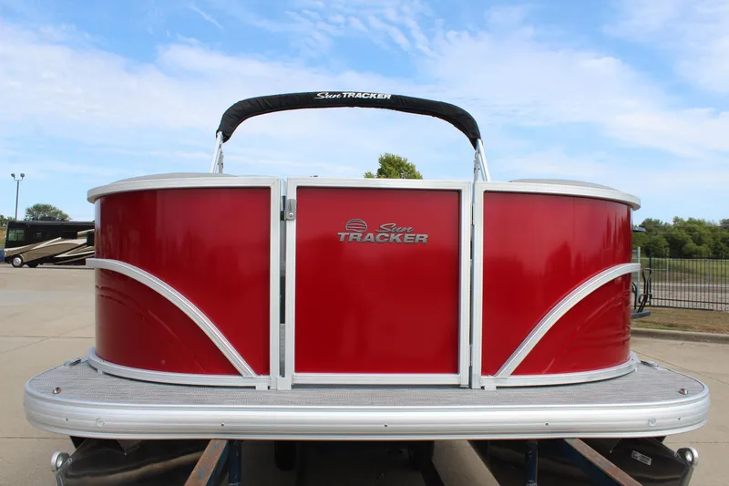 Slide: The Image of 2026 Sun Tracker Party Barge 16 DLX pontoon boat, red exterior, parked outdoors. - 2