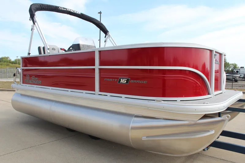 Slide: The Image of 2026 Sun Tracker Party Barge 16 DLX pontoon boat, red exterior, docked outdoors. - 3