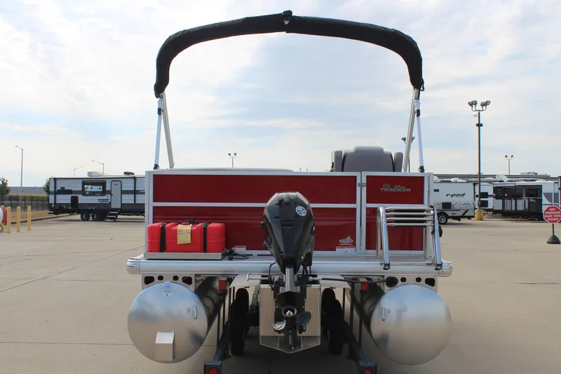 Slide: The Image of 2026 Sun Tracker Party Barge 16 DLX pontoon boat with outboard motor, parked in lot. - 6