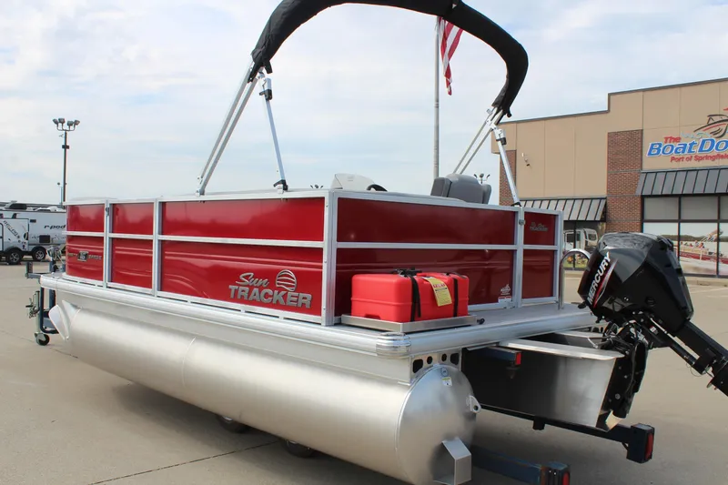 Slide: The Image of 2026 Sun Tracker Party Barge 16 DLX pontoon boat with red exterior and Mercury outboard motor. - 7