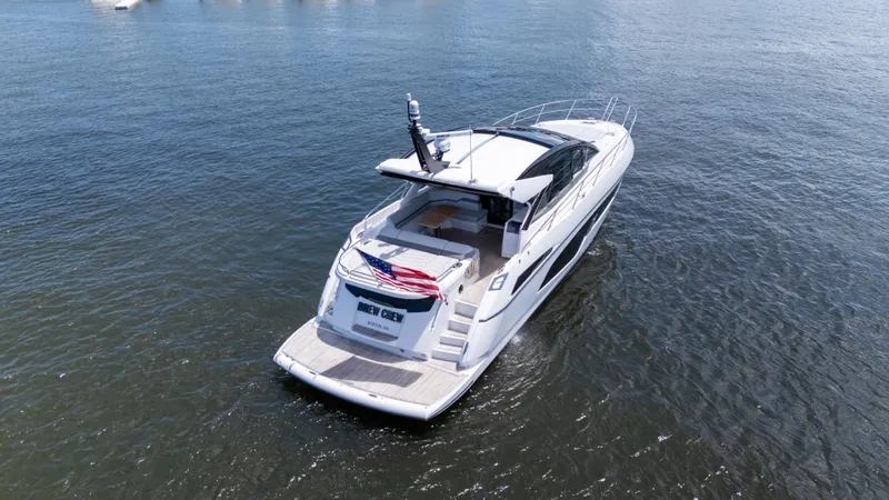 Slide: The Image of 2022 Sunseeker Predator 60 yacht cruising on open water, rear view. - 10
