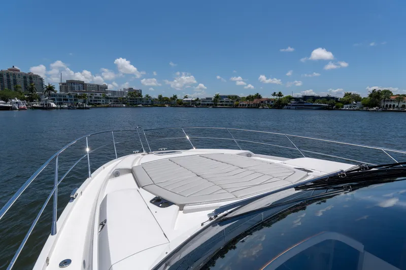 Slide: The Image of 2022 Sunseeker Predator 60 yacht cruising on a sunny day with waterfront view. - 12