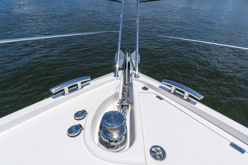 Slide: The Image of Bow of 2022 Sunseeker Predator 60 yacht with anchor and railing, on water. - 13