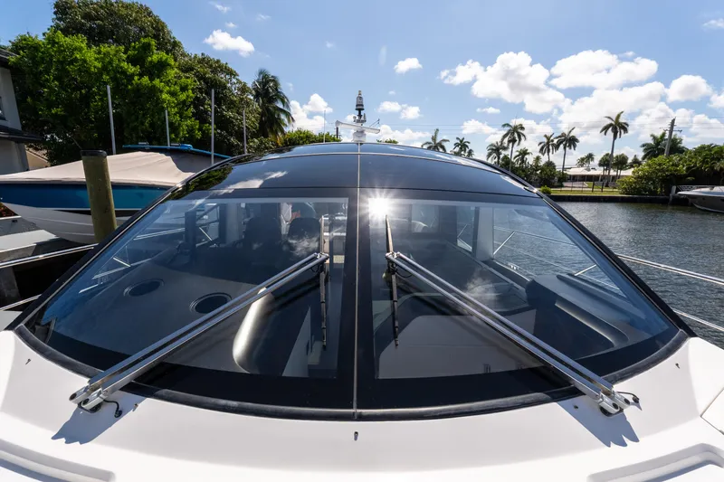 Slide: The Image of Sunseeker Predator 60 yacht, 2022 model, docked with sleek design and sunlit windows. - 15