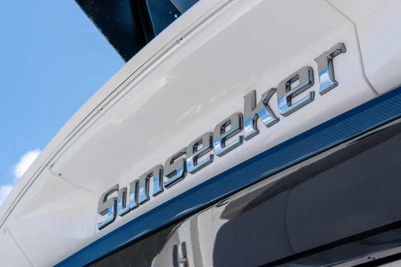 Slide: The Image of Sunseeker Predator 60 yacht logo, 2022 model, close-up view against blue sky. - 17