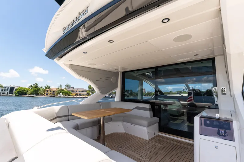 Slide: The Image of Luxurious 2022 Sunseeker Predator 60 yacht with spacious outdoor seating and scenic waterfront view. - 20