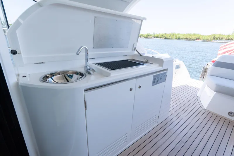 Slide: The Image of Outdoor kitchenette on 2022 Sunseeker Predator 60 yacht, featuring sink and grill. - 26