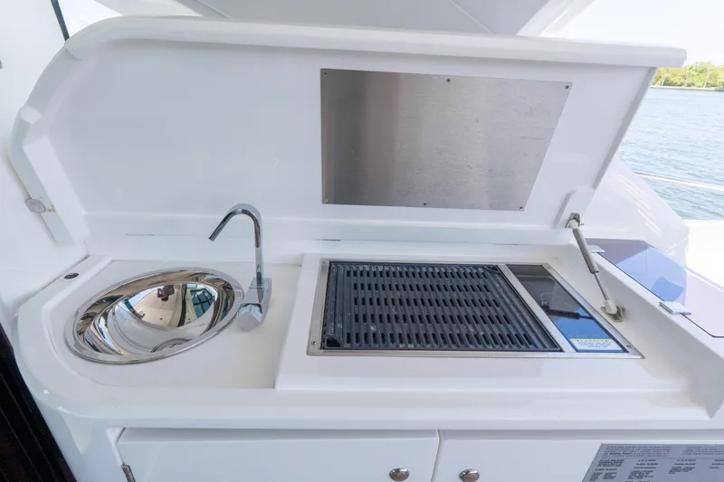 Slide: The Image of Outdoor kitchen on 2022 Sunseeker Predator 60 yacht with sink and grill. - 27
