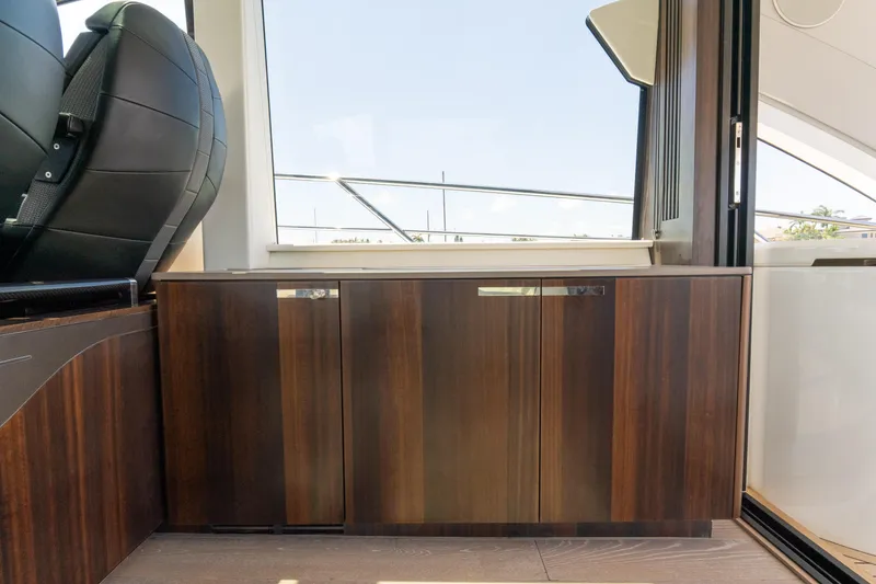 Slide: The Image of Interior of 2022 Sunseeker Predator 60 yacht, featuring sleek wooden cabinetry. - 30