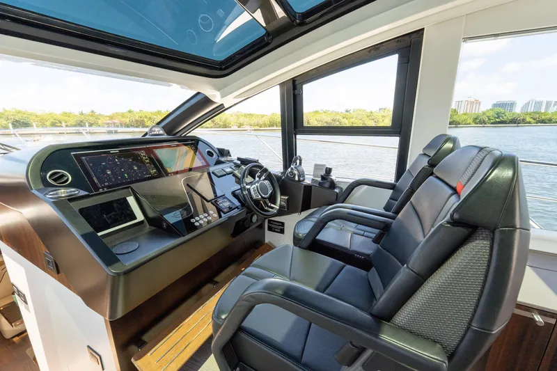 Slide: The Image of Interior cockpit of 2022 Sunseeker Predator 60 yacht with modern controls and leather seating. - 35