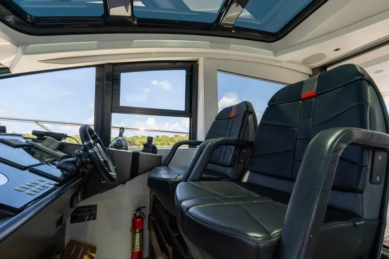 Slide: The Image of Interior of 2022 Sunseeker Predator 60 yacht cockpit with leather seats and steering wheel. - 36