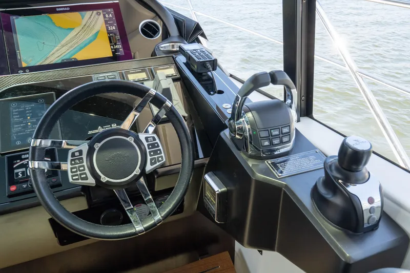 Slide: The Image of Helm of 2022 Sunseeker Predator 60 yacht with advanced navigation controls and display. - 38