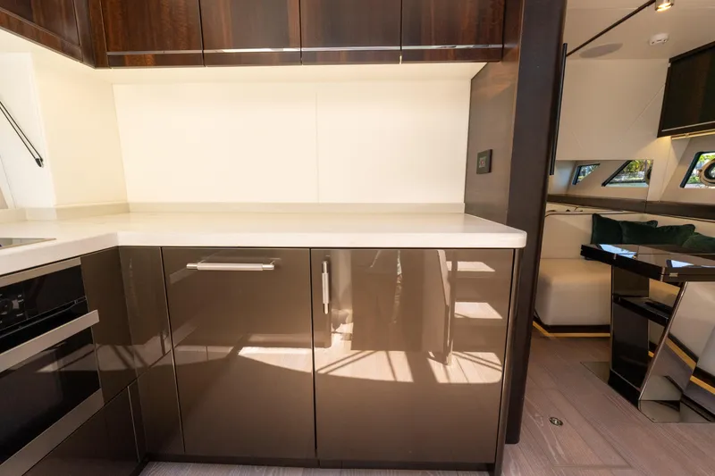 Slide: The Image of Luxurious Sunseeker Predator 60 yacht interior, featuring modern kitchen cabinetry and sleek design, 2022 model. - 43