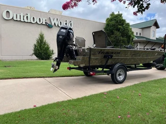 Slide: The Image of 2023 Tracker 1654SPT boat on trailer outside Outdoor World store. - 5